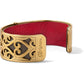 Brighton hinged cuff bracelet with gold-plated scrollwork design, engraved logo, and red leather interior on a white background