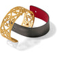 Brighton cuff bracelet with gold-plated scroll filigree design and reversible red and gray leather strap on a white background