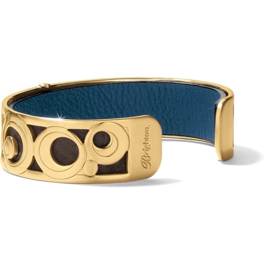 Brighton cuff bracelet with gold-plated circular openwork design and blue leather interior lining on a white background