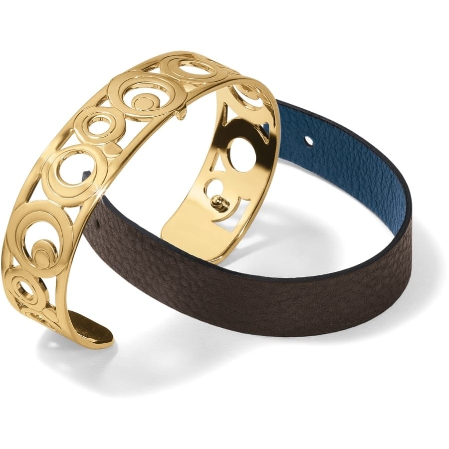 Brighton bracelet with gold-plated openwork cuff and brown leather strap with blue interior on a white background