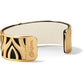 Brighton cuff bracelet with gold-plated cutout design over black leather and cream interior on a white background