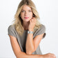 Model wearing a Brighton silver-plated cuff bracelet with textured wave pattern paired with silver-plated stud earrings