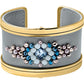 Brighton cuff bracelet with gray leather, gold-tone trim, and blue crystal beaded centerpiece on a white background