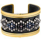 Brighton cuff bracelet in black leather with gold-tone trim and silver and dark crystal beaded floral design on a white background