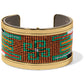 Brighton cuff bracelet with green, orange, brown, and white beaded pattern and gold-tone frame on a white background