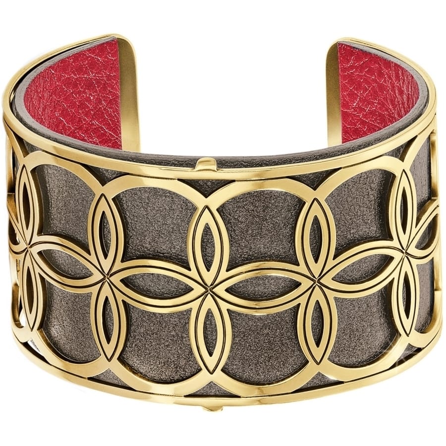 Brighton cuff bracelet with gold-plated floral cutout design over gunmetal base and red leather interior on a white background
