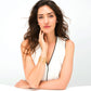 Model wearing a Brighton gold-plated cuff bracelet with openwork interlocking circle design, paired with crystal stud earrings