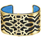 Brighton cuff bracelet with gold-plated geometric openwork design over black and blue leather on a white background