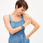 Model wearing a Brighton silver-plated cuff bracelet with openwork scroll pattern paired with a heart pendant necklace