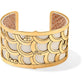 Brighton cuff bracelet with gold-plated scalloped scale design over white leather insert on a white background