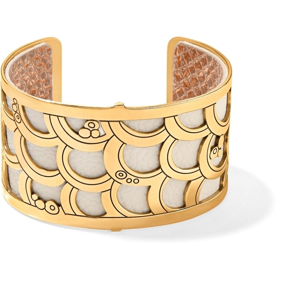 Brighton cuff bracelet with gold-plated scalloped scale design over white leather insert on a white background