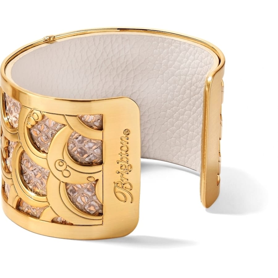 Brighton gold-plated cuff bracelet with scalloped cutout design, snakeskin leather insert, and engraved logo on a white background