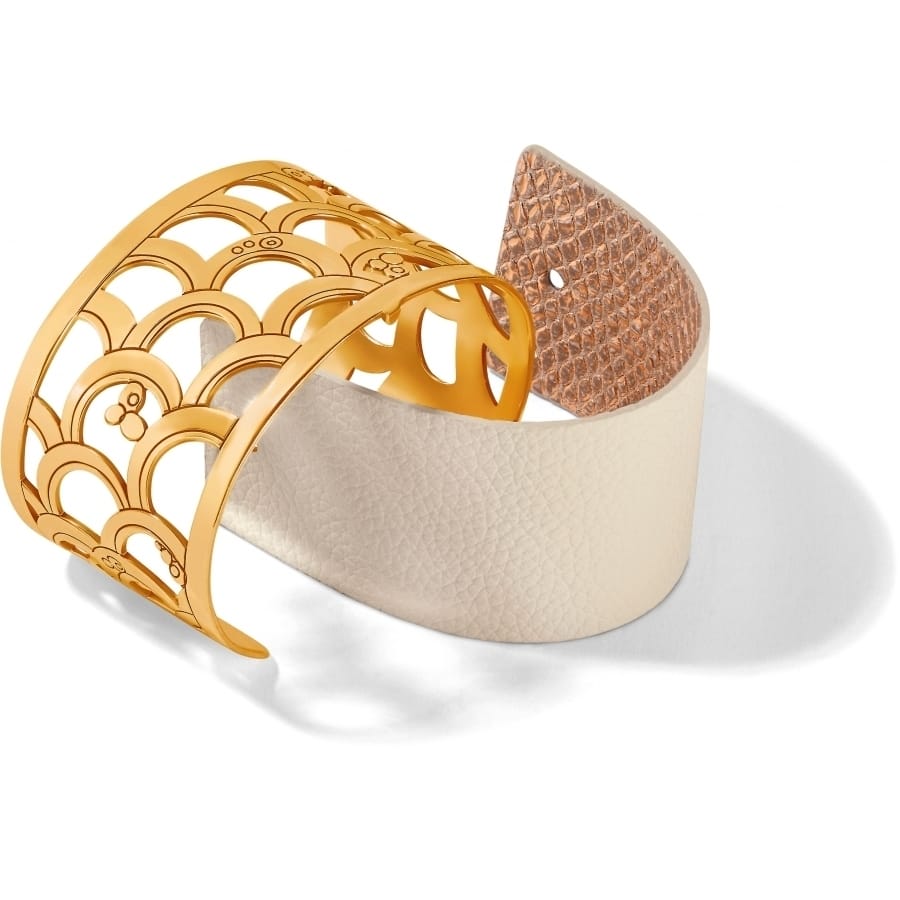 Brighton cuff bracelet with gold-plated scalloped openwork design and cream leather insert on a white background