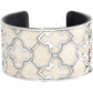Brighton cuff bracelet with silver-plated quatrefoil scrollwork over cream leather inlay on a white background