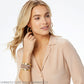 Model wearing Brighton gold-tone crystal hoop earrings paired with a leather cuff bracelet with ornate beaded detail