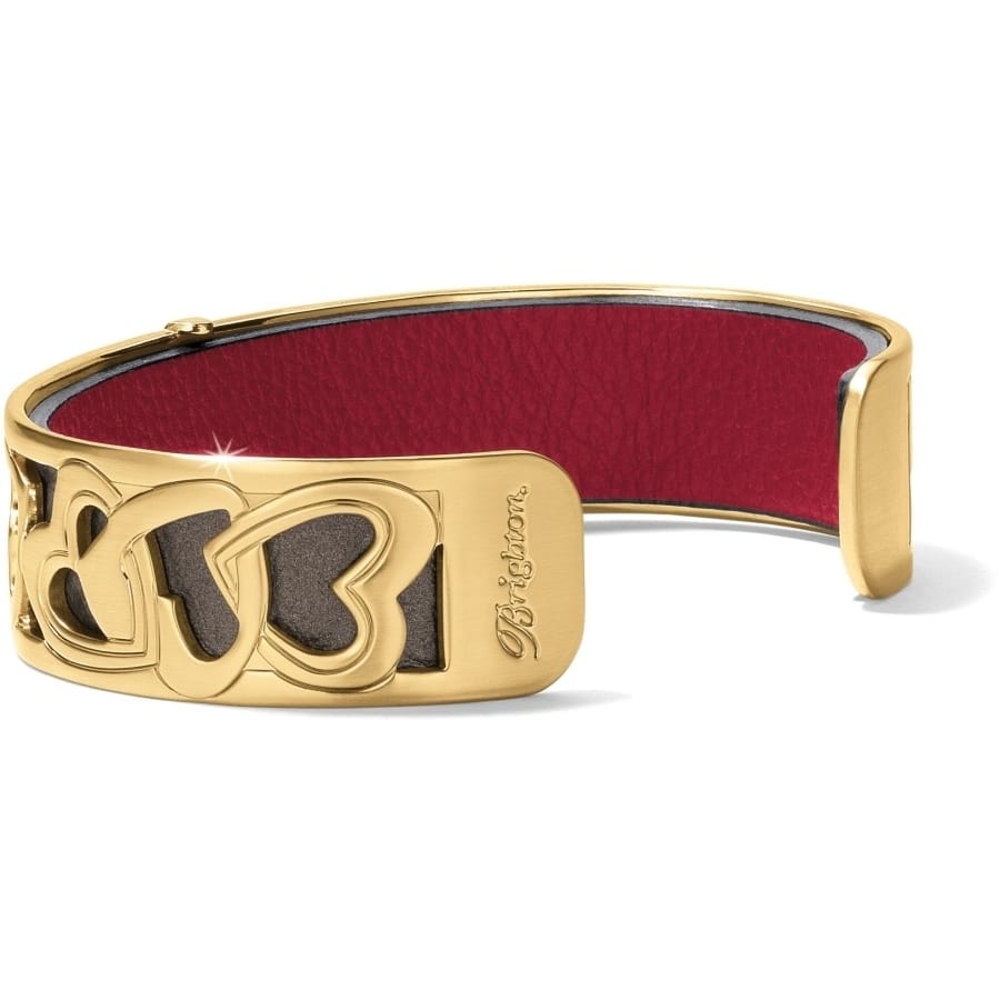Brighton cuff bracelet with gold-plated interlocking hearts design and red leather inlay on a white background