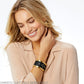 Model wearing a Brighton black leather cuff bracelet with quilted pattern, crystal accents, and gold-tone trim
