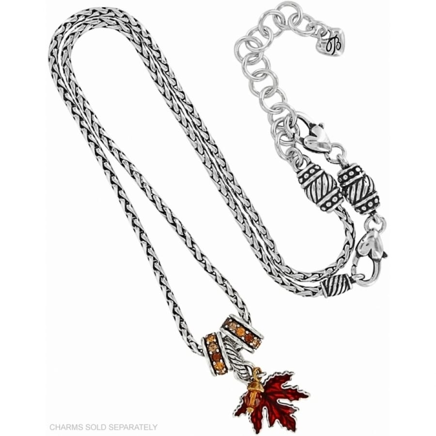 Brighton silver-plated chain necklace with red enamel maple leaf charm and amber crystal accents on a white background