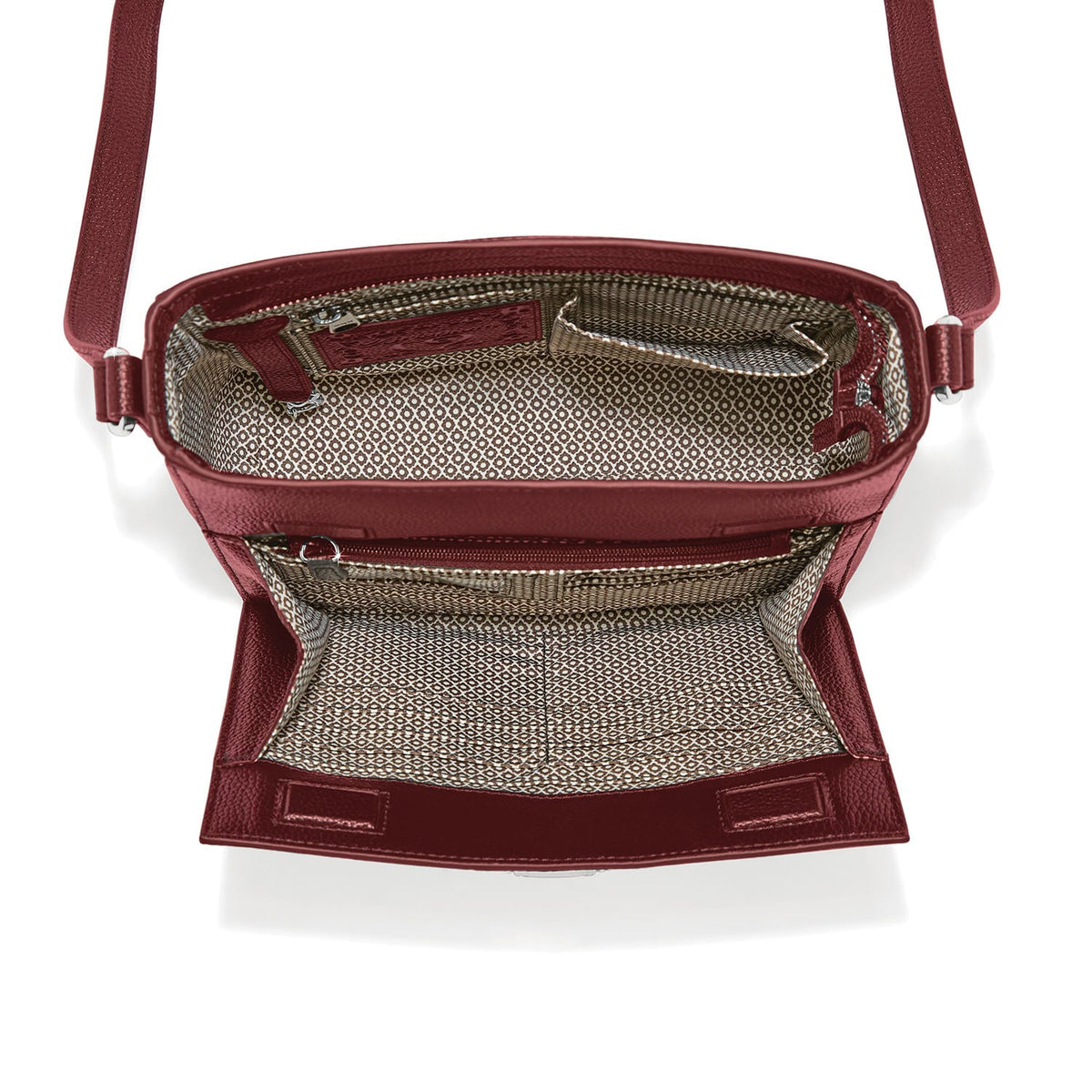 Brighton burgundy crossbody handbag shown open with patterned fabric interior, zip pocket, and adjustable strap on a white background