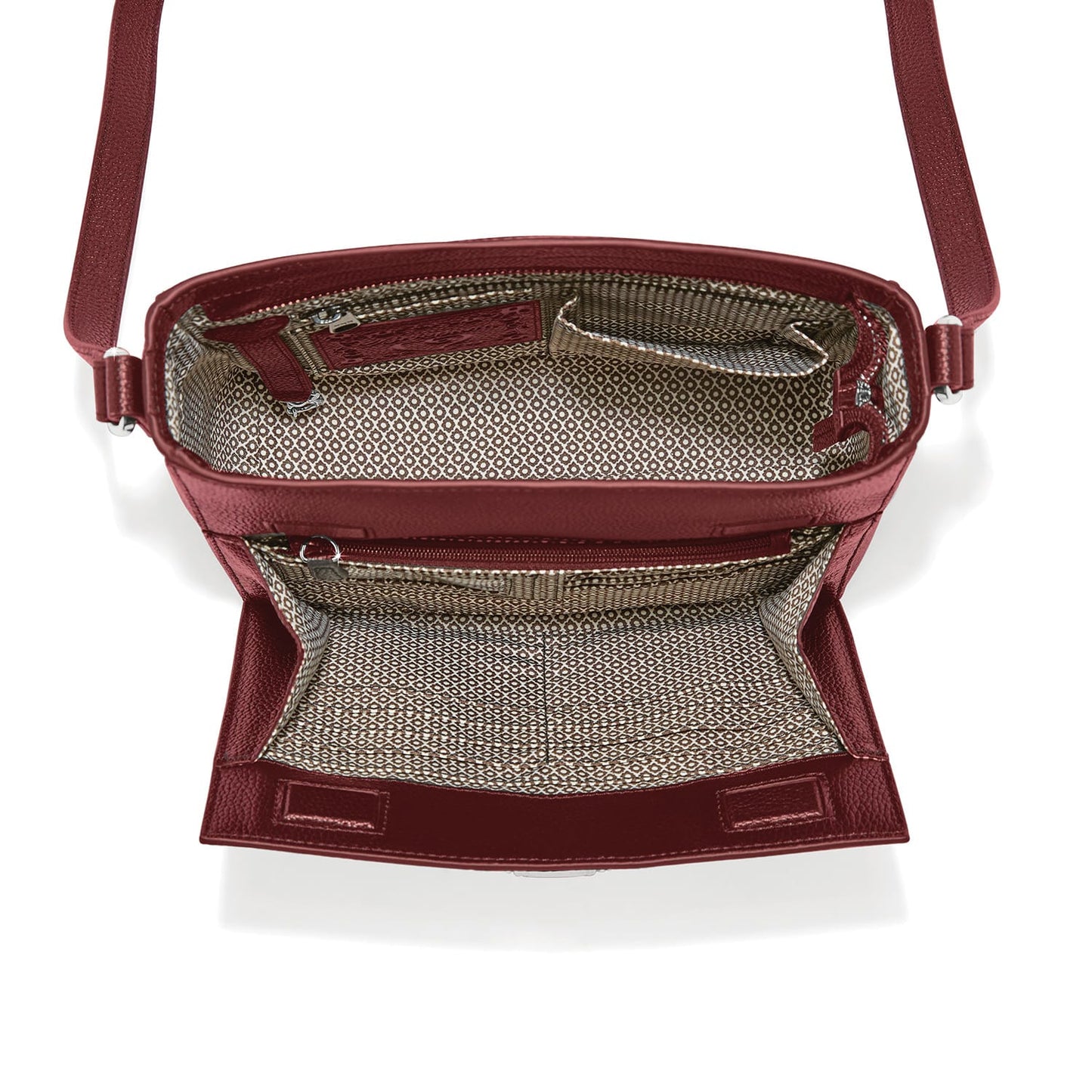 Brighton burgundy crossbody handbag shown open with patterned fabric interior, zip pocket, and adjustable strap on a white background
