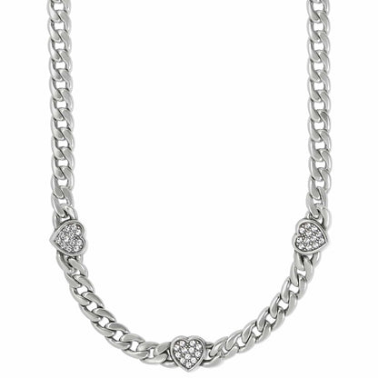 Brighton silver-plated curb chain necklace with three crystal-set heart stations on a white background