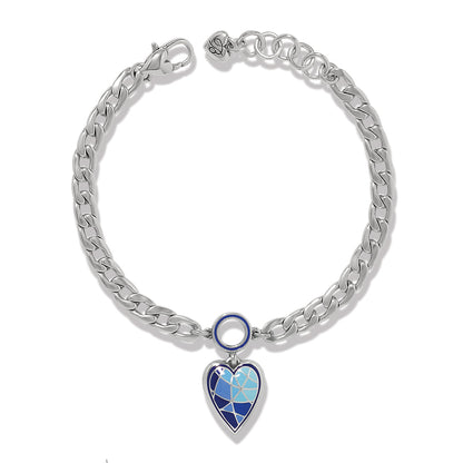 Brighton charm bracelet with silver-plated curb chain and blue enamel heart pendant on a white background