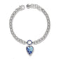 Brighton charm bracelet with silver-plated curb chain and blue enamel heart pendant on a white background