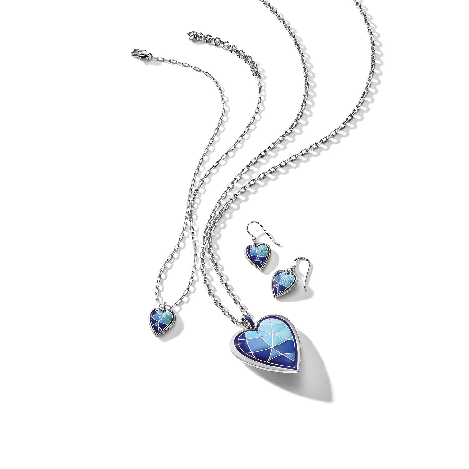 Brighton heart pendant necklace and matching drop earrings with blue enamel mosaic design and silver-plated chains on a white background