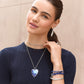 Model wearing a Brighton silver-plated heart pendant necklace with blue enamel mosaic and coordinating Brighton accessories