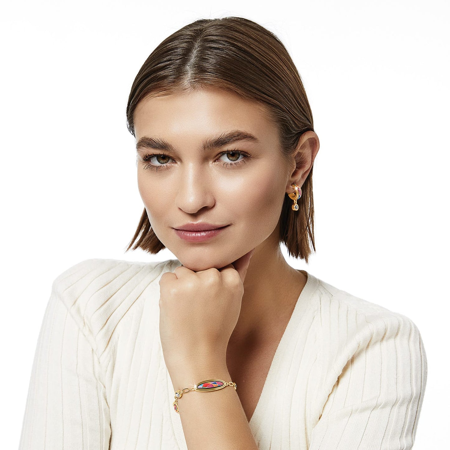 Model wearing Brighton gold-plated hoop earrings with colorful enamel and crystal accents paired with matching bracelet