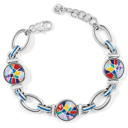 Brighton bracelet with three multicolored enamel mosaic discs, silver-plated links, and blue enamel accents on a white background
