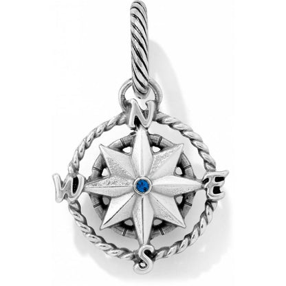 Brighton compass charm with silver-plated rose design, blue crystal center, and rope-twist frame on a white background