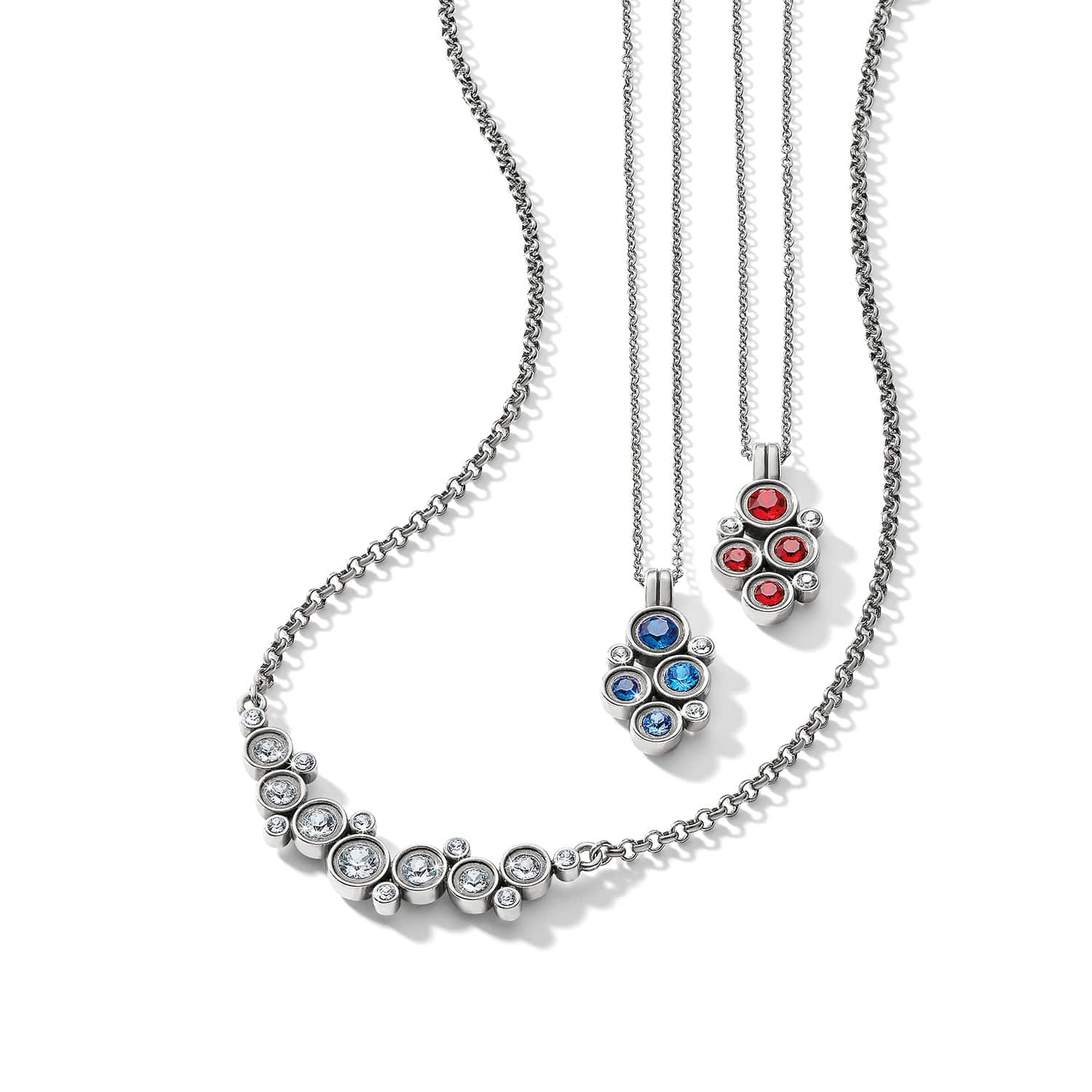Brighton silver-plated necklaces with clustered clear, blue, and red crystal pendants on a white background