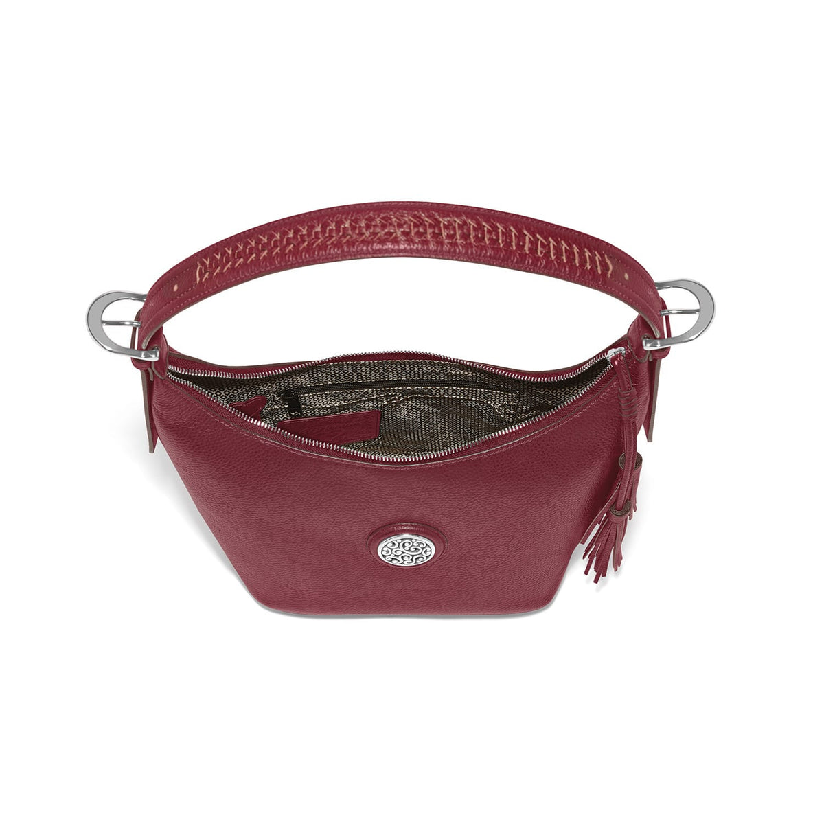 Brighton red leather handbag shown open with interior zip pocket, silver-tone rings, and tassel detail on a white background