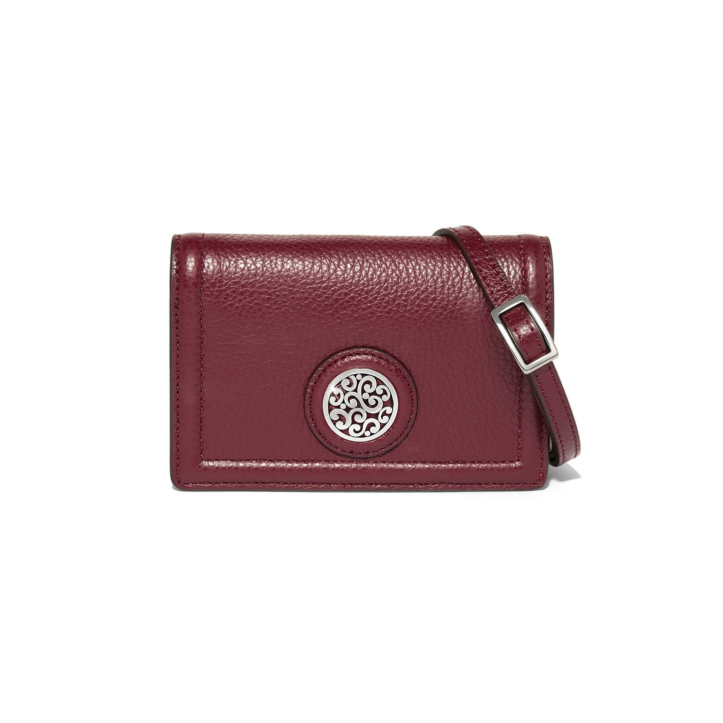 Brighton burgundy leather crossbody handbag with silver-tone medallion emblem and adjustable strap on a white background