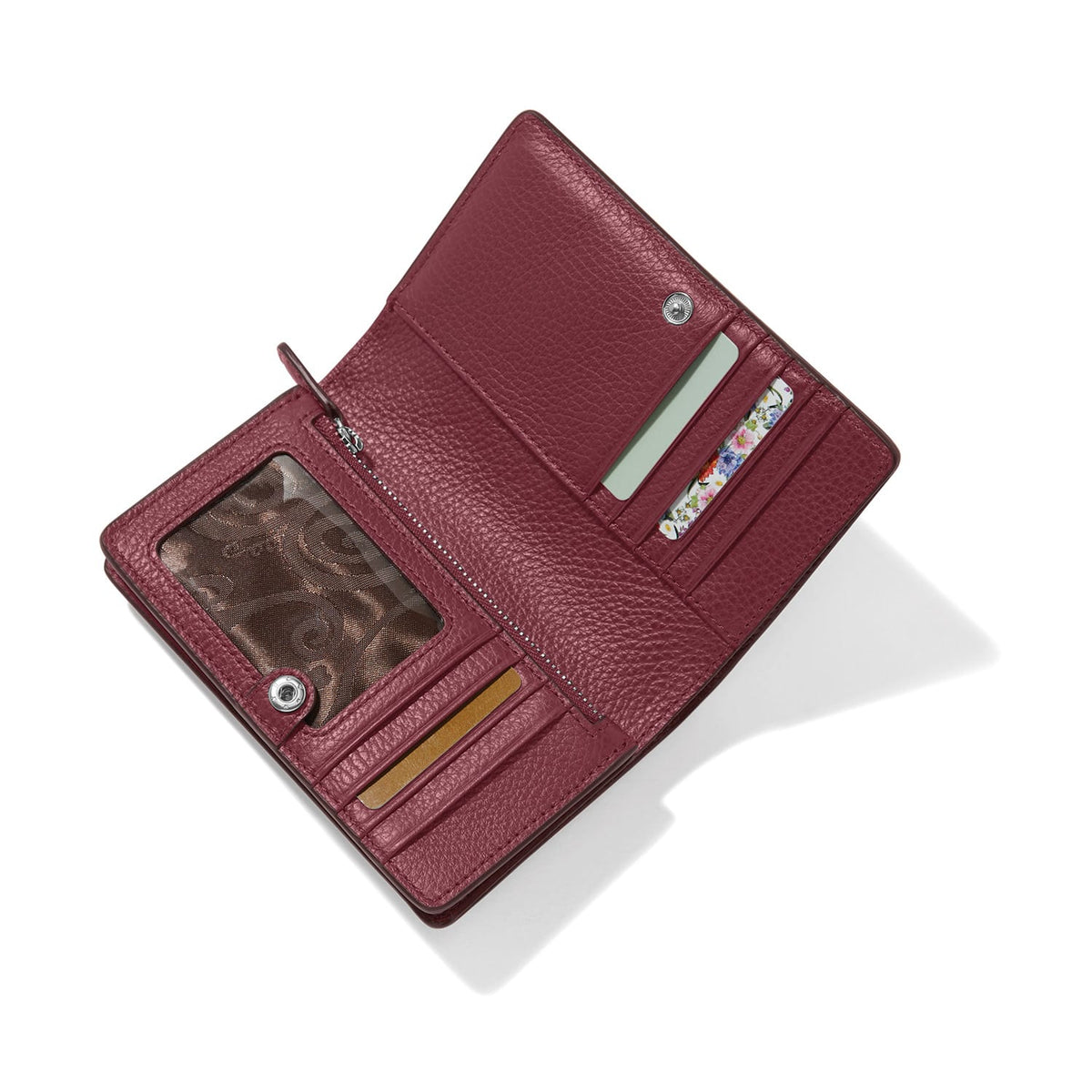 Brighton burgundy leather wallet shown open with multiple card slots, ID window, and zippered pocket on a white background