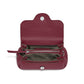 Brighton burgundy leather handbag shown open with patterned fabric interior, zip pocket, and silver-tone snap closure on a white background