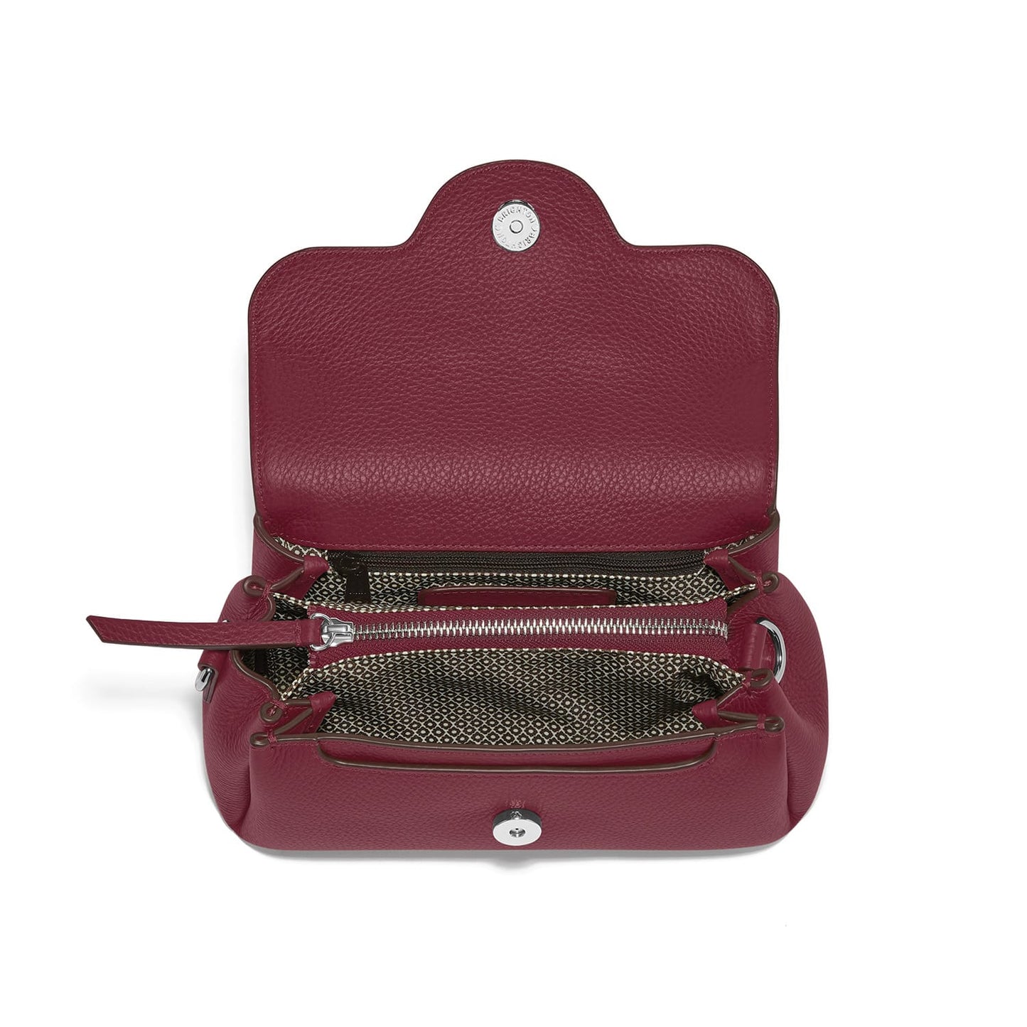 Brighton burgundy leather handbag shown open with patterned fabric interior, zip pocket, and silver-tone snap closure on a white background