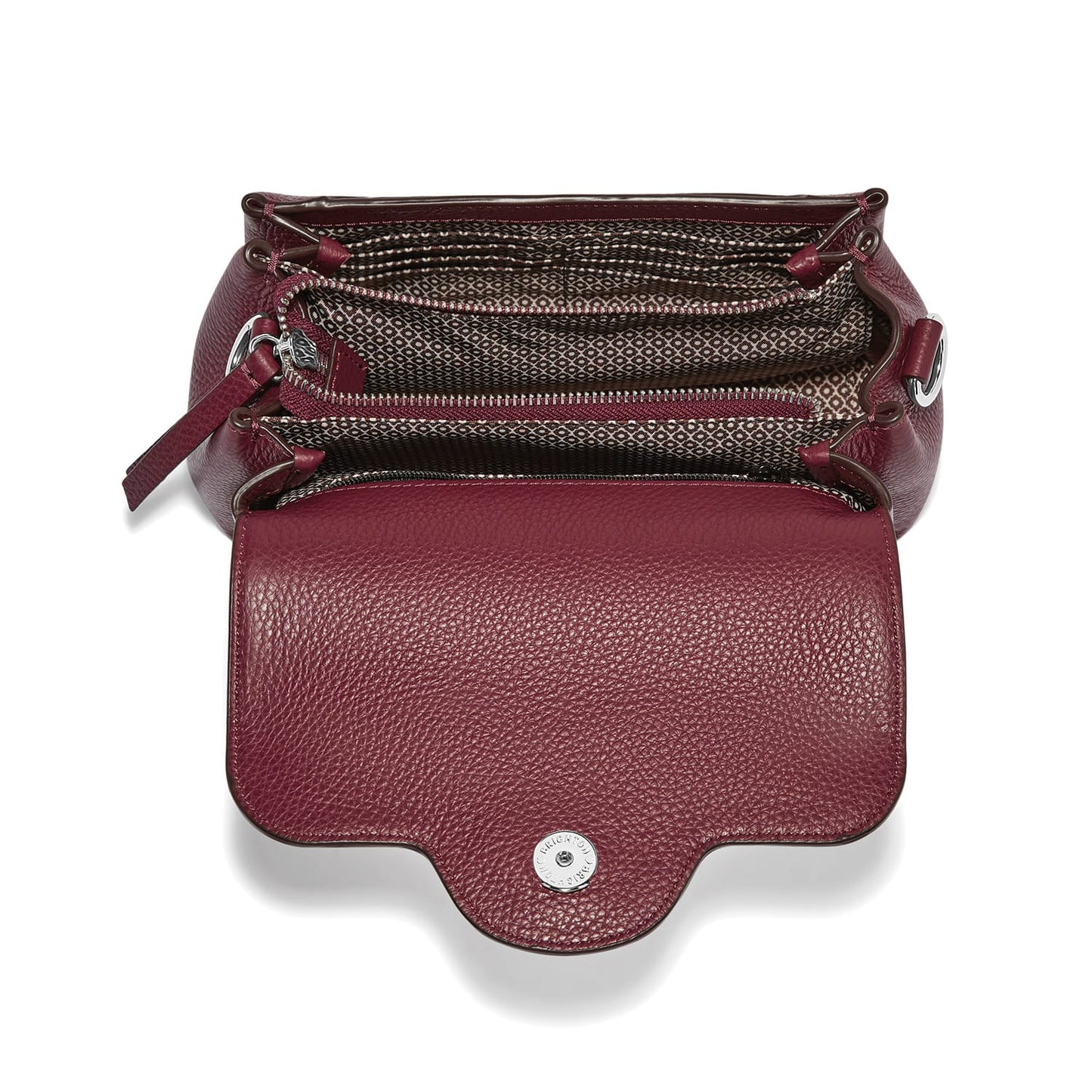 Brighton burgundy leather handbag shown open with patterned fabric interior and silver-tone snap closure on a white background