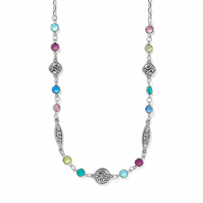 Brighton silver-plated necklace with multicolored crystals and ornate scrollwork medallions on a white background
