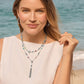 Model wearing a Brighton silver-plated layered necklace with multicolor crystals and tassel drop, paired with hoop earrings