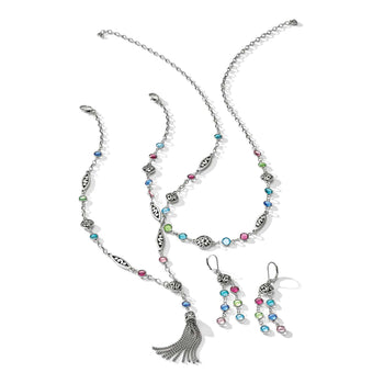 Brighton silver-plated jewelry set with multicolored crystals, scroll-detail links, tassel pendant necklace, and matching earrings on a white background