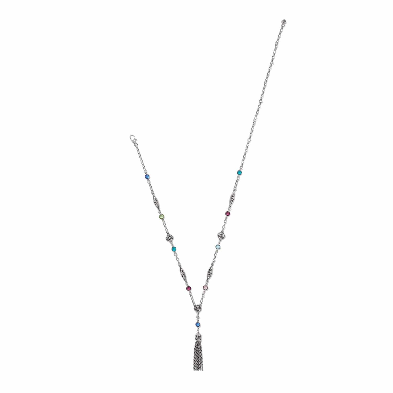 Brighton silver-plated tassel necklace with multicolored crystal stations and engraved scrollwork links on a white background