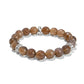 Brighton beaded stretch bracelet with faceted brown stone beads and silver-plated accent spacers on a white background