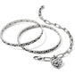 Brighton silver-plated bangle bracelets and chain link bracelet with scroll heart charm on a white background