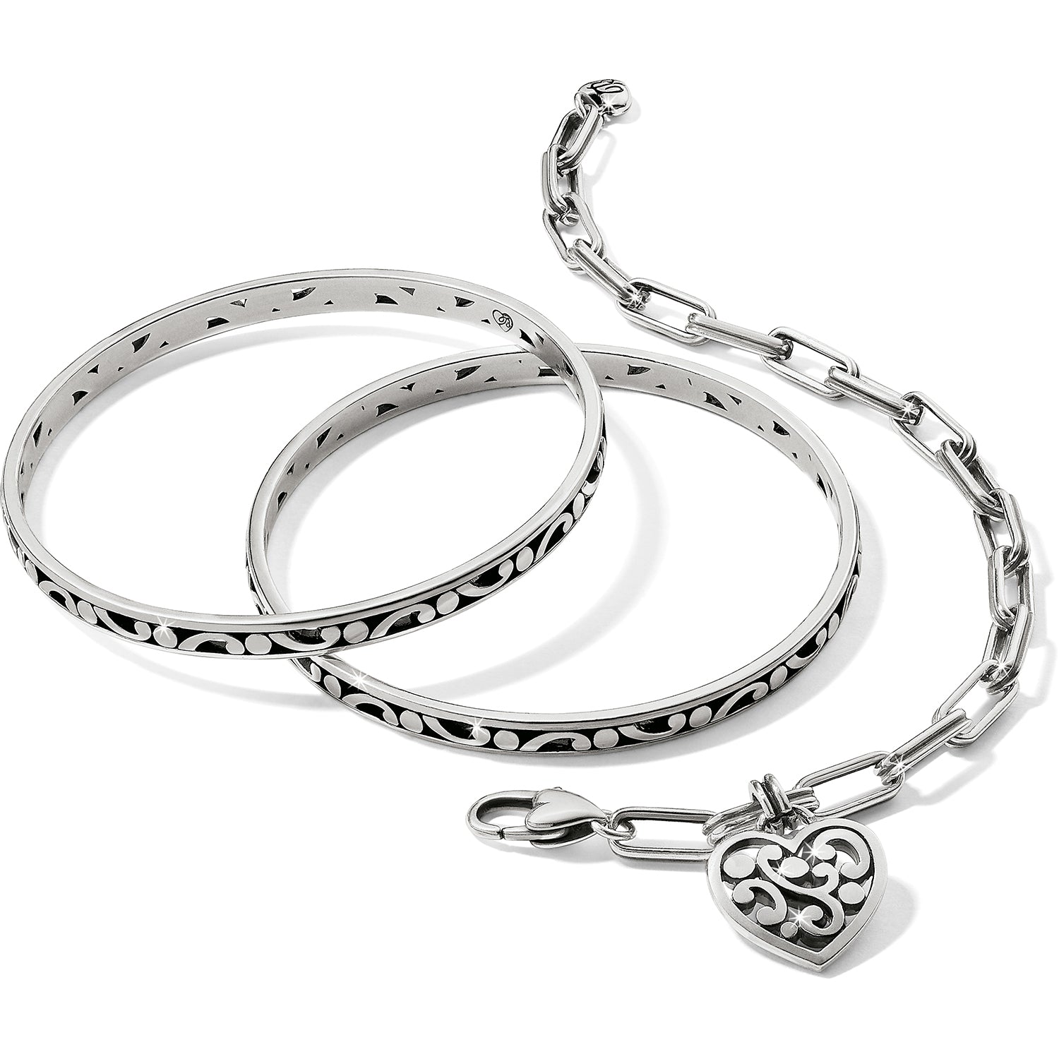 Brighton silver-plated bangle bracelets and chain link bracelet with scroll heart charm on a white background