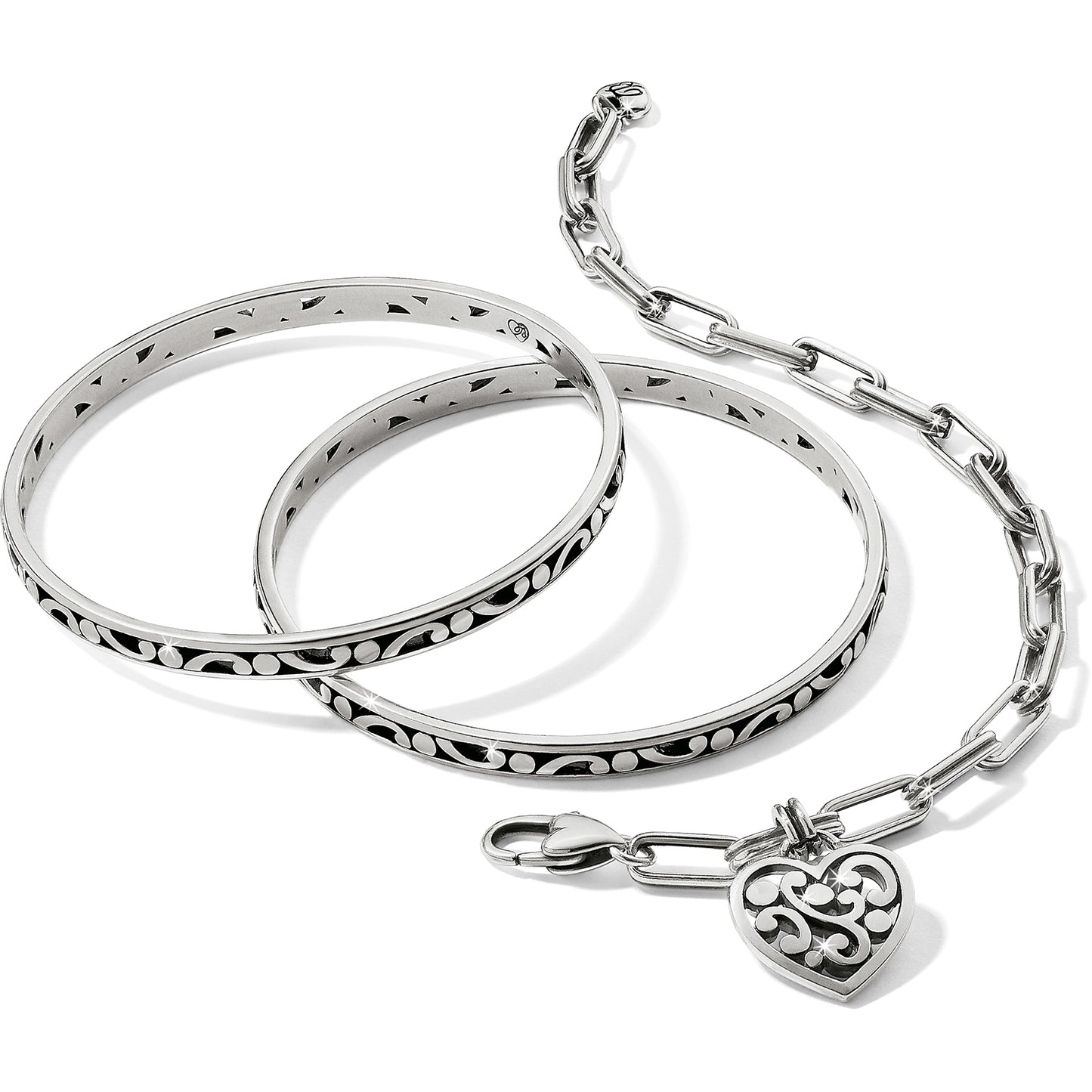 Brighton silver-plated bangle bracelets and chain link bracelet with scroll heart charm on a white background