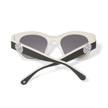 Brighton sunglasses shown from the back with white frames, black temples, and silver-tone scroll medallions on a white background
