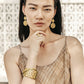 Model wearing Brighton gold-tone filigree drop earrings with coordinating Brighton stacked rings and openwork cuff bracelet