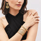 Model wearing Brighton gold-tone filigree drop earrings with coordinating Brighton bangles and a wide ring